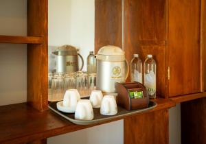 a shelf with a coffee maker and bottles on it at Talpe Paradise in Galle