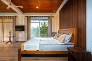 a bedroom with a large bed and a large window at Talpe Paradise in Galle