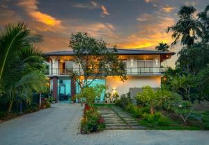 a house with a pathway in front of it at Talpe Paradise in Galle