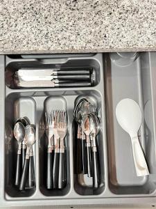 a drawer with utensils in a kitchen sink at Bacolod Condo CASA LEA in Bacolod
