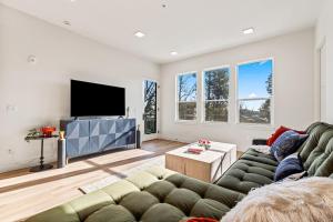 a living room with a couch and a flat screen tv at Emerald City in Downtown Eagle in Eagle
