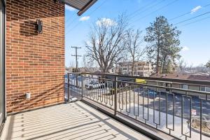 a balcony with a metal railing and a brick building at Emerald City in Downtown Eagle in Eagle