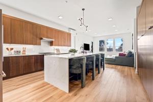 a kitchen with a large white counter top and wooden cabinets at Emerald City in Downtown Eagle in Eagle