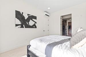 a bedroom with a bed and a painting on the wall at Emerald City in Downtown Eagle in Eagle
