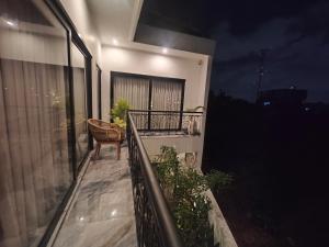 a balcony with a chair on a building at night at Santo Guesthouse in Canggu