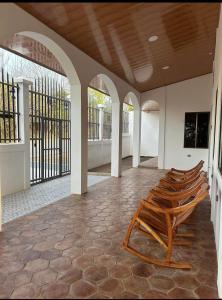 a row of chairs in a room with a ceiling at Casa 12-87 in Poneloya