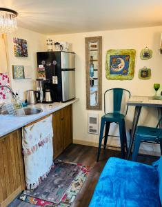 a kitchen with a sink and a counter with a microwave at Magnolia Petal Accommodation in Salt Spring Island +22 photos