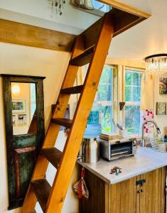 a wooden ladder in a kitchen with a counter at Magnolia Petal Accommodation in Salt Spring Island