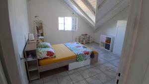 a bedroom with a bed in a room at Chez Valé in Le Moule