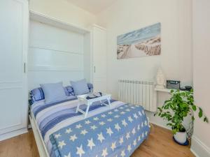 a bedroom with a bed with a table on it at The Beach Studio in Brighton & Hove