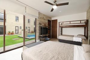 a bedroom with a bed and a large window at Bungalows in Samsara Atlixco in La Sabana +30 photos