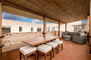 a patio with a wooden table and chairs at Bungalows in Samsara Atlixco in La Sabana