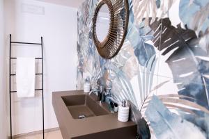 a bathroom with a sink and a mirror at Profumo Antico - Luxury Guesthouse by STHEY in Monopoli