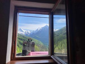 a window with a view of a mountain at La Casetta Prali in Prali