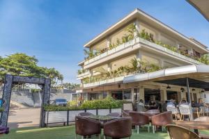a building with tables and chairs in front of it at Afro Park Hotel in Kampala
