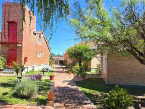a brick walkway next to a brick building at La Margarita Lofts - Solo 2 Adultos in Mina Clavero