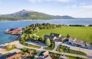 an aerial view of a house on the shore of a lake at Experience Senja in Senja
