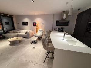 a kitchen and living room with a white counter top at Ourthe Basse in La-Roche-en-Ardenne