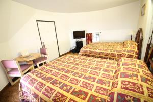 Un ou plusieurs lits dans un hébergement de l'établissement Wigwam Motel