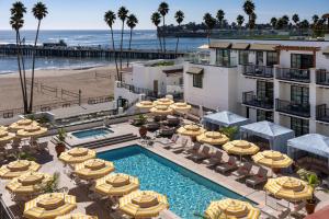 an aerial view of a hotel with umbrellas and the beach at La Bahia Hotel & Spa in Santa Cruz
