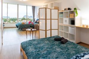 a bedroom with a bed and a living room at Tableau de La Ciotat - Host Provence in La Ciotat