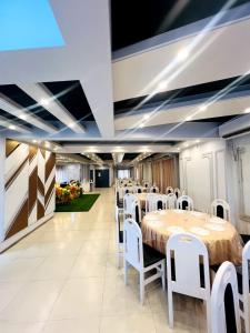 a conference room with tables and white chairs at Hotel Istanbul Sylhet in Sylhet