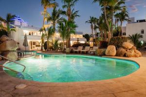 a swimming pool in the middle of a resort at Hotel & Suites El Moro in La Paz
