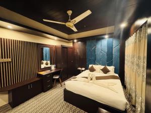 a bedroom with a bed and a desk in it at Hotel Istanbul Sylhet in Sylhet