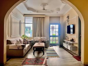 a living room with a couch and a table at Ayu Aanandam - Live I Heal I Rest in Rishīkesh