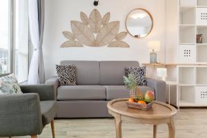 a living room with a couch and a table with a bowl of fruit at Tableau de La Ciotat - Host Provence in La Ciotat +63 photos