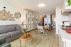 a living room and kitchen with a couch and a table at Tableau de La Ciotat - Host Provence in La Ciotat