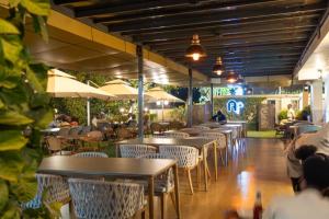 a restaurant with tables and chairs and umbrellas at Afro Park Hotel in Kampala