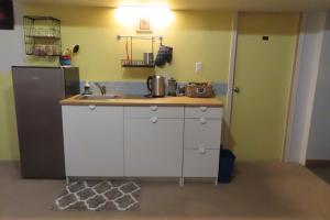 a kitchen with a sink and a refrigerator at Friendly Footprint in Golden