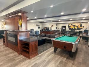 a living room with a pool table and a couch at Black Gold Suites Stanley in Stanley