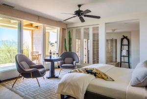 a bedroom with two chairs and a bed and a window at Sttupa Estate Napa Valley in Napa