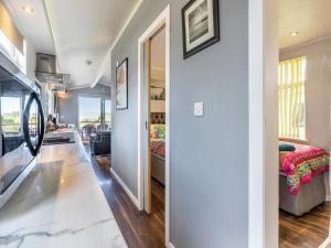 a bedroom with a bed and a hallway with a mirror at Tranquillity in Dinas