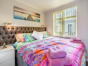 a bedroom with a large bed and a window at Tranquillity in Dinas