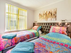 a bedroom with two beds and a window at Tranquillity in Dinas +9 photos