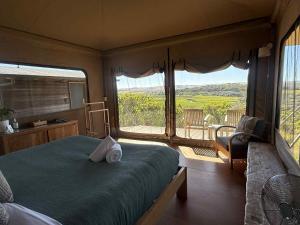 a bedroom with a bed and a window with a view at Pebble Point in Princetown