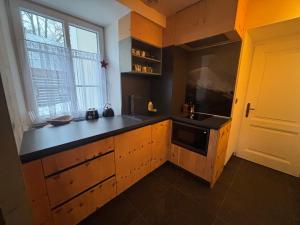 a kitchen with a black counter top and a sink at Útulný apartmán Vitkovice in Vítkovice