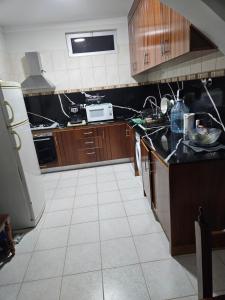 a kitchen with wooden cabinets and a black counter top at I Love Tanque in Caculi