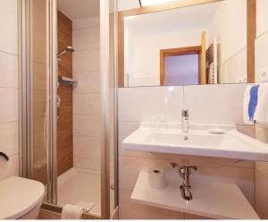 a white bathroom with a sink and a shower at Haus Traudl in Filzmoos +27 photos