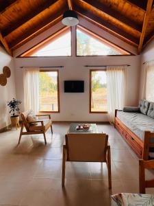 a living room with a bed and a table at Los Robles Patagonia in Esquel