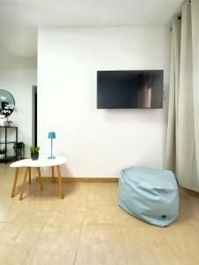 a room with a table and a blue bag on the floor at NextGen Dimora Luna I Private Garden & Pool Fuerteventura in Costa de Antigua +15 photos