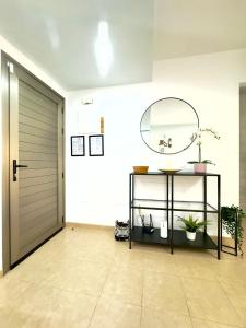 a hallway with a mirror and a shelf with plants at NextGen Dimora Luna I Private Garden & Pool Fuerteventura in Costa de Antigua