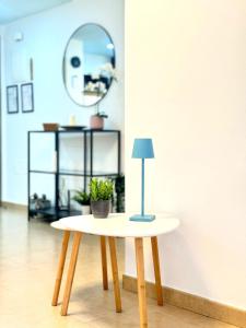 a table with a lamp on it in a room at NextGen Dimora Luna I Private Garden & Pool Fuerteventura in Costa de Antigua