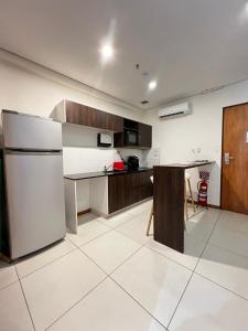 a kitchen with a refrigerator and a table in it at The One DownTown Costanera in Asunción