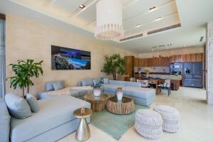 a living room with a blue couch and tables at Ana y Jose Tulum Hotel & Beach Club in Tulum