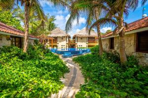 a view of a resort with palm trees at Ana y Jose Tulum Hotel & Beach Club in Tulum