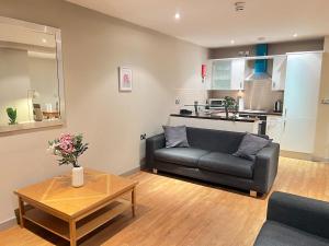 a living room with a couch and a coffee table at Comfy 2bed flat next to Motorpoint Arena in Nottingham